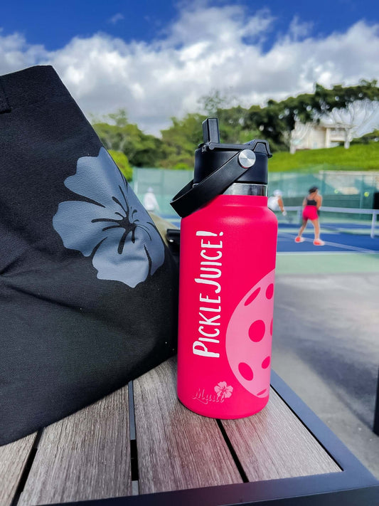pink pickleball water bottle on the court with a bag 