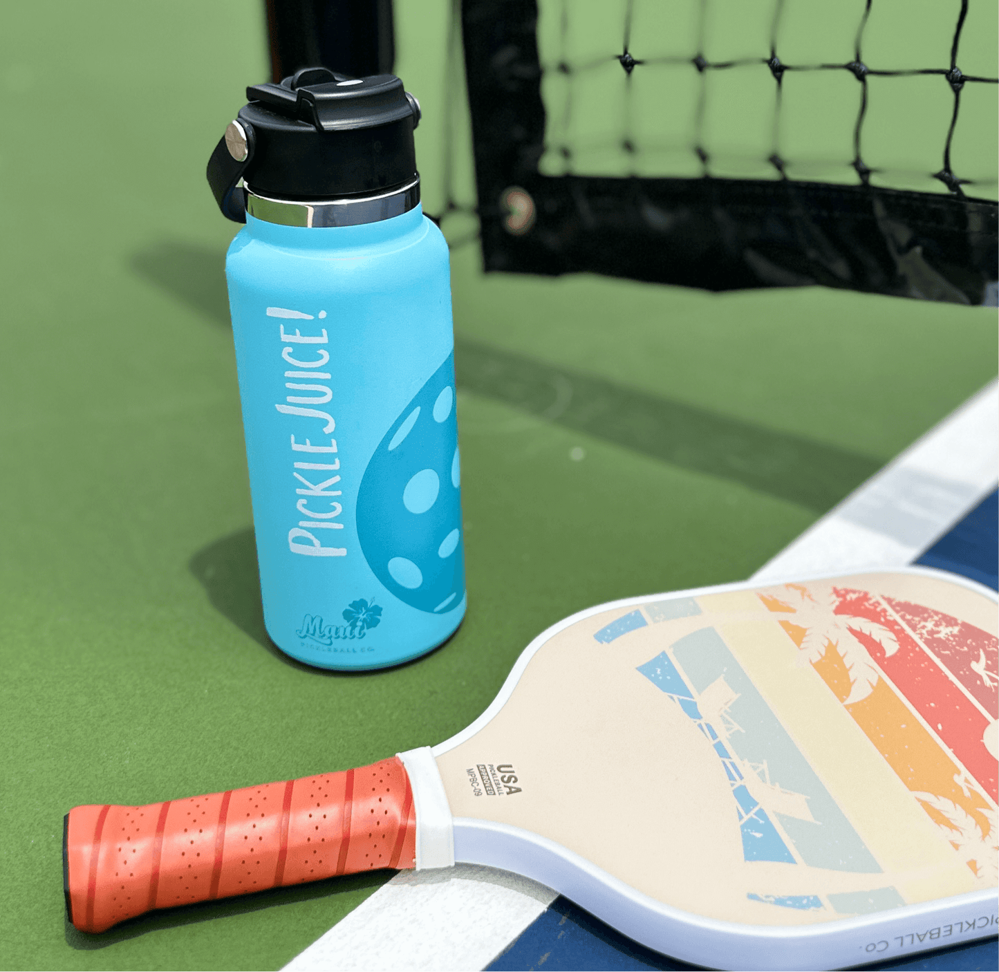 aqua stainless steel water bottle and a rainbow pickleball paddle on a court