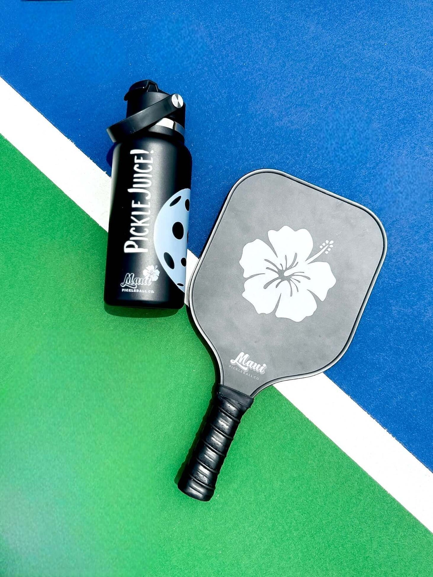 pickleball paddle on the court with a paddle and pickleball water bottle 